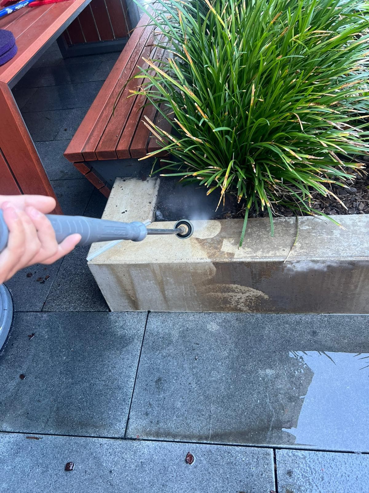 Pressure washing garden retaining wall and outdoor paving