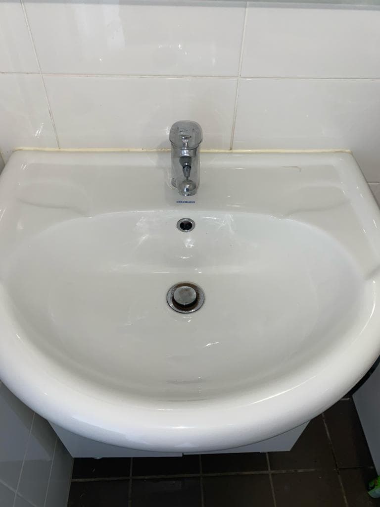 Spotless bathroom vanity, polished chrome tap, white basin
