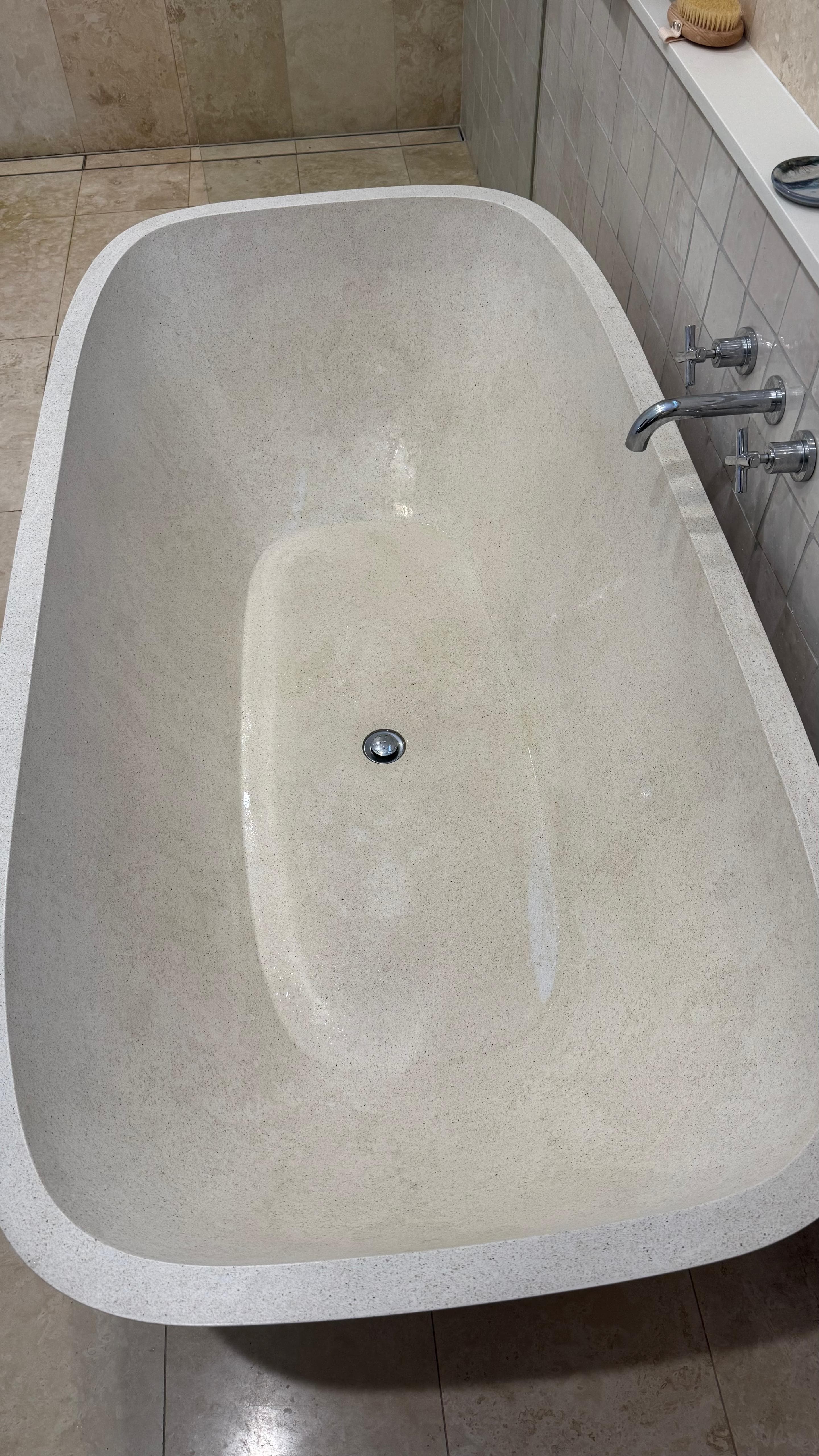 Pristine marble freestanding bathtub after deep clean, North Shore property