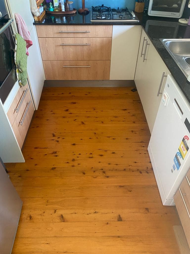 Kitchen after end-of-lease clean, floors mopped, benches detailed
