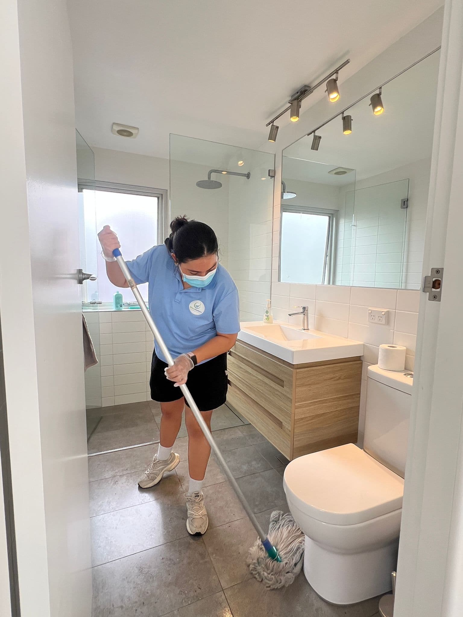 ShineMasters cleaner mopping bathroom floor, residential deep clean North Shore